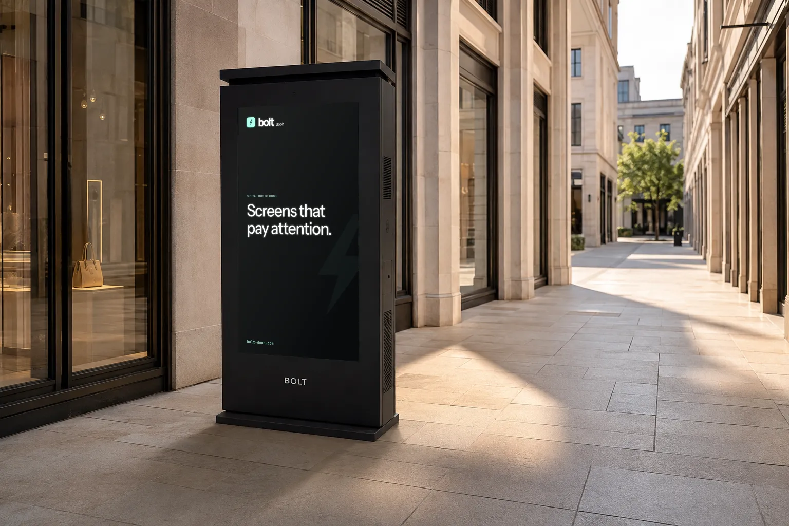 BOLT outdoor totem visualisation with a substantial vented cabinet and rain cap in a sunlit stone shopping arcade